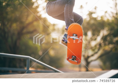 Asian woman skateboarder skateboarding at skatepark Asian woman skateboarder skateboarding at skatepark 74589716