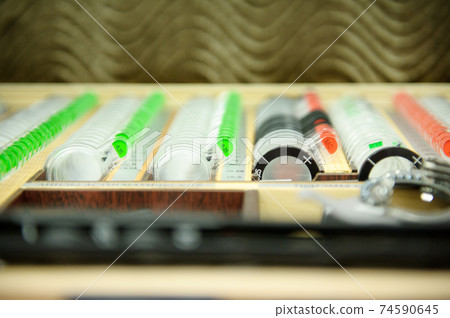 The concept of ophthalmology. The plates contain concave lenses, convex lenses, cylindrical lenses for measuring vision The concept of ophthalmology. The plates contain concave lenses, convex lenses, cylindrical lenses for measuring vision 74590645
