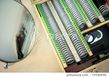 The concept of ophthalmology. The plates contain concave lenses, convex lenses, cylindrical lenses for measuring vision 74590646