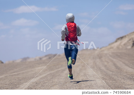 Fitness woman trail runner cross country running on sand desert 74590684