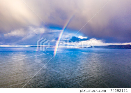 Aerial view of an rainbow above the Atlantic Ocean in Donegal - Ireland Aerial view of an rainbow above the Atlantic Ocean in Donegal - Ireland 74592151