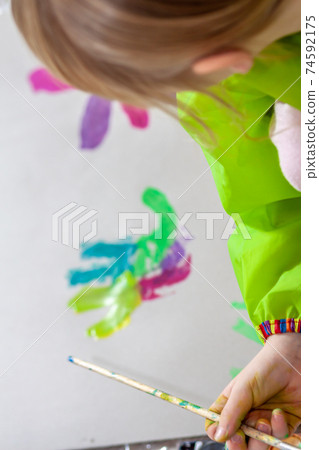 Little girl using watercolour at home during the pandemic lockdown Little girl using watercolour at home during the pandemic lockdown 74592175