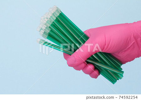 Dentist's hand in glove with saliva ejectors. 74592254