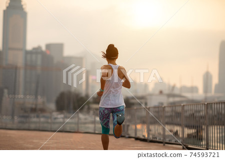 Healthy lifestyle woman runner running on hong kong city Healthy lifestyle woman runner running on hong kong city 74593721