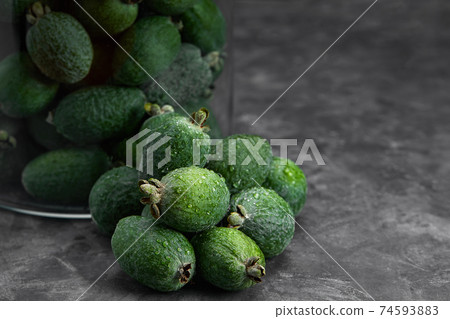 Feijoa whole on black background. Exotic fruit. Selective focus. Closeup. Feijoa whole on black background. Exotic fruit. Selective focus. Closeup. 74593883