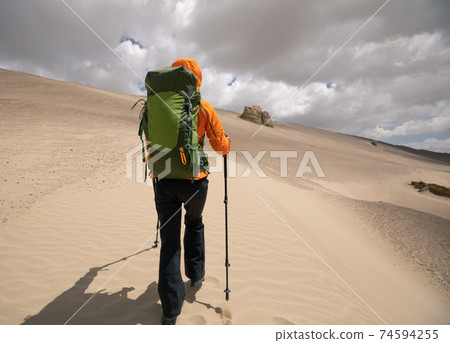 Backpacke solo hiking on desert 74594255