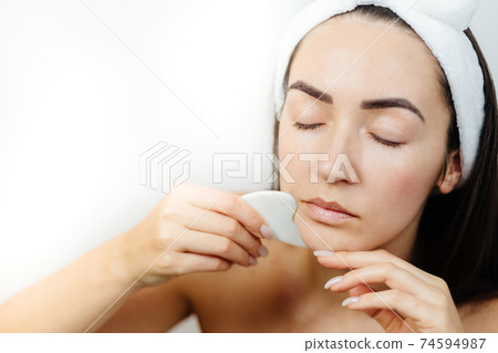 woman using gouache scraper massager woman using gouache scraper massager 74594987