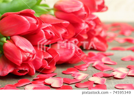 Bouquet of red tulips, silk red hearts on brown wooden planks table close up view selective focus. Spring holidays, Womens, spring, love, romantic, flowers, garden, Easter card, banner, template 74595349