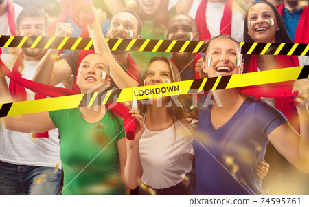 Italian soccer fans cheering for favourite sport team with bright emotions, excited, wondered behind the limiting tapes with Lockdown 74595761