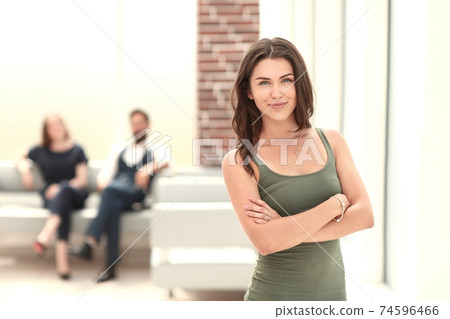 smiling young woman standing in Bank office. 74596466
