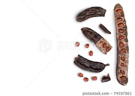 Ripe carob pods and bean isolated on white background with clipping path. Top view with copy space for your text. Flat lay Ripe carob pods and bean isolated on white background with clipping path. Top view with copy space for your text. Flat lay 74597861