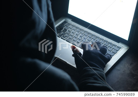 hacker hand stealing data from laptop top down hacker hand stealing data from laptop top down 74599089