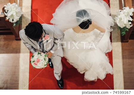 A bride and groom walking on a virgin road A bride and groom walking on a virgin road 74599167