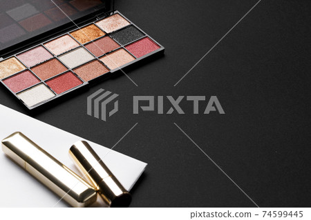 various makeup products on black texture background. various makeup products on black texture background. 74599445