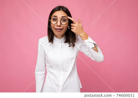 Photo shot of beautiful funny young brunette woman wearing casual clothes and stylish optical Photo shot of beautiful funny young brunette woman wearing casual clothes and stylish optical 74600031