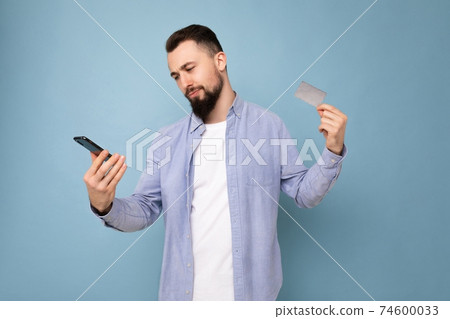Photo shot of handsome positive good looking young man wearing casual stylish outfit poising Photo shot of handsome positive good looking young man wearing casual stylish outfit poising 74600033