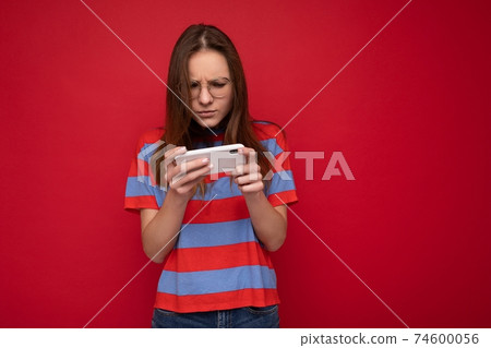 Concentrated attractive good looking young woman wearing optical glasses and casual stylish outfit 74600056