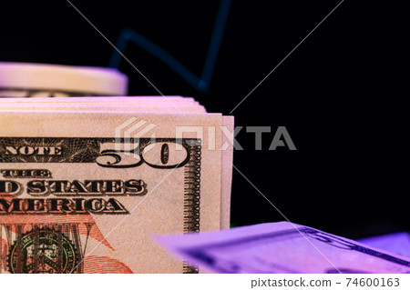 American dollar banknotes and graph on black background 74600163
