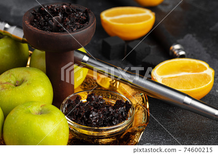 Shisha parts with apples and lemons on table Shisha parts with apples and lemons on table 74600215