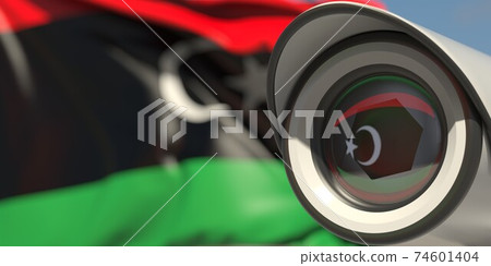 National flag of Libya and CCTV camera. Surveillance system conceptual 3D rendering National flag of Libya and CCTV camera. Surveillance system conceptual 3D rendering 74601404