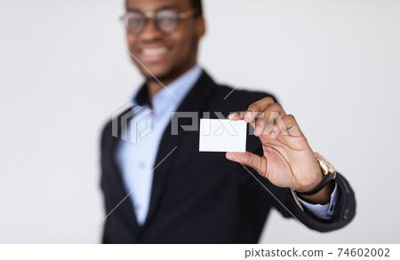 Black businessman holding blank card for clients Black businessman holding blank card for clients 74602002