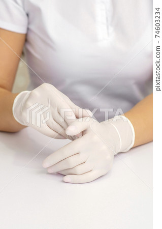 Two hands in protective gloves Two hands in protective gloves 74603234