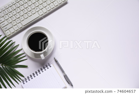 Top view of coffee with other supplies and keyboard on white background and copy space for insert text. Top view of coffee with other supplies and keyboard on white background and copy space for insert text. 74604657