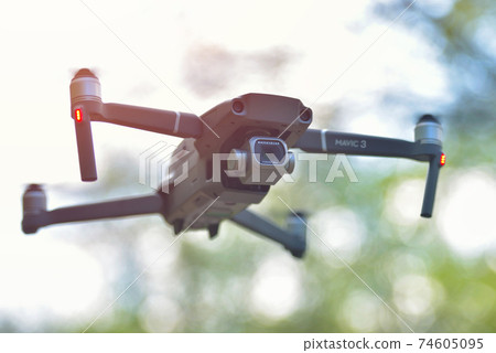 Galati, Romania - February 15, 2021: Dji Mavic 3 Pro with Hasselblad camera hovering inside a forrest in bright daylight 74605095