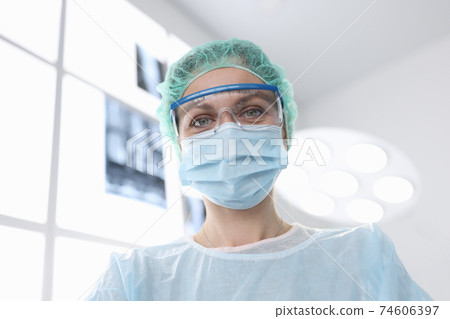 Woman surgeon in sterile suit in operating room 74606397