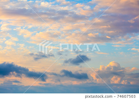 Gentle colors of sundown sunset sky with beautiful light clouds Gentle colors of sundown sunset sky with beautiful light clouds 74607503