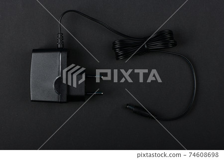 Black power ac to dc adaptor. 74608698