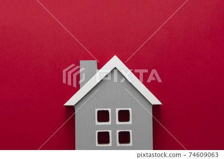 House insurance and mortgage, buying or rent concept.Wooden model house over red background, top view with copy space 74609063