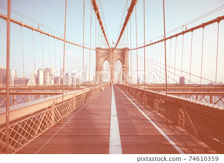 Retro color toned picture of Brooklyn Bridge, New York City, USA. 74610359