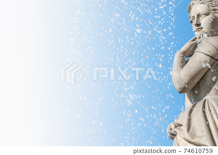 Beautiful young girl under water drops as element of State Opera fountain in Vienna in front of blue sky, Austria, details, closeup Beautiful young girl under water drops as element of State Opera fountain in Vienna in front of blue sky, Austria, details, closeup 74610759