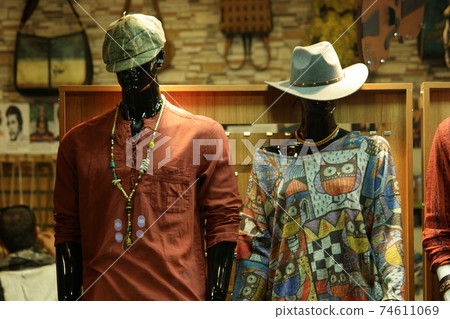 Male and female mannequins dressed in casual clothes. 74611069