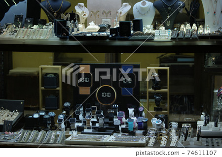 Collection of necklaces and earrings at jewelry store. 74611107