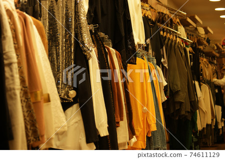 Clothes hanging on rack close up. 74611129