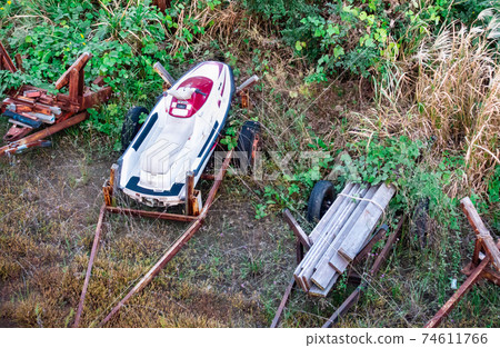A photo of a small boat left in the grass. A photo of a small boat left in the grass. 74611766