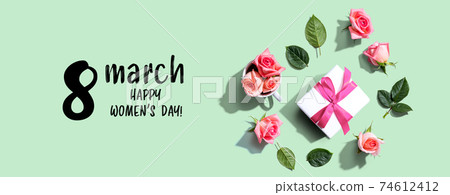 Happy womens day message with a gift box and roses Happy womens day message with a gift box and roses 74612412