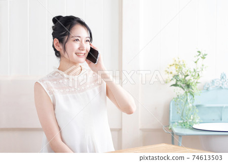 A woman using a smartphone A woman using a smartphone 74613503