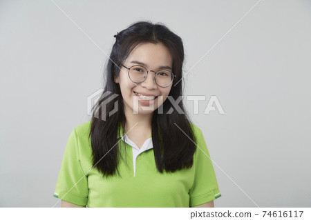 Asian woman portrait with a green shirt Asian woman portrait with a green shirt 74616117