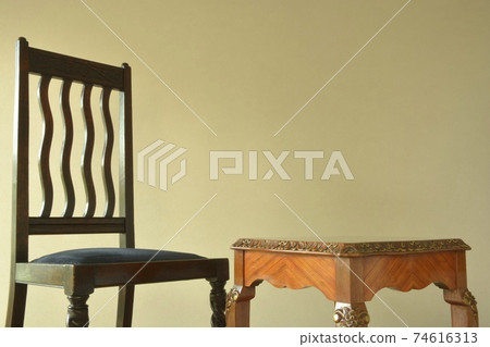 Mahogany table and oak chair. Layout of British antique furniture (copy space, soft focus) Mahogany table and oak chair. Layout of British antique furniture (copy space, soft focus) 74616313
