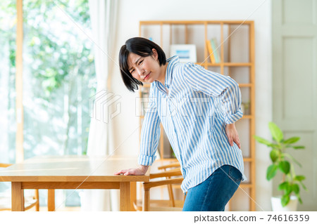Young woman with a backache 74616359