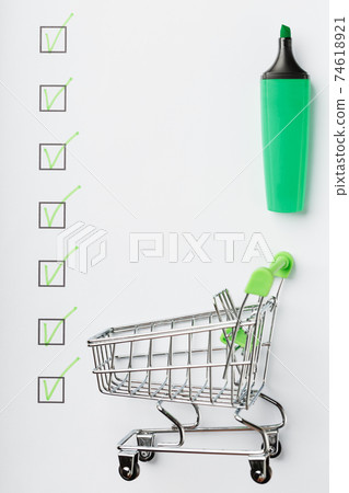 Supermarket Cart and Green Marker Marked on the Checklist Sheet. Supermarket Cart and Green Marker Marked on the Checklist Sheet. 74618921