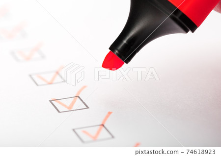Orange marker with markers on the checklist sheet. Orange marker with markers on the checklist sheet. 74618923
