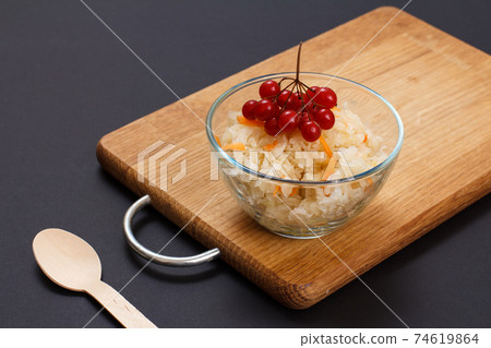 Fermented cabbage with herbs and spices in glass bowl on the black background Fermented cabbage with herbs and spices in glass bowl on the black background 74619864