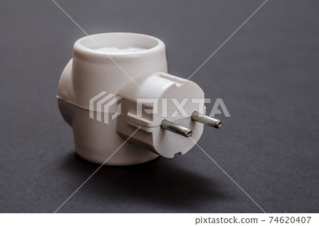 White electrical tee on a black background. White electrical tee on a black background. 74620407