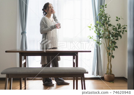 A woman yawning to wake up 74620948