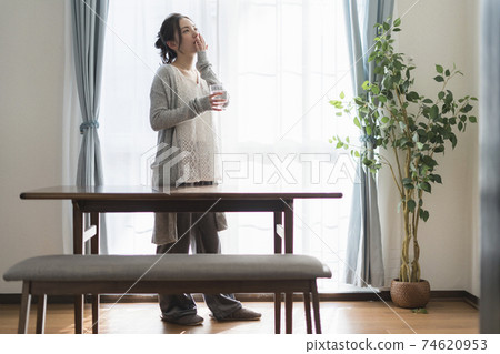 A woman yawning to wake up 74620953