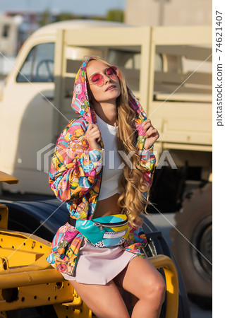 Stylish female sitting on vehicle Stylish female sitting on vehicle 74621407